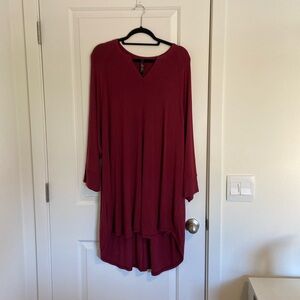 Melissa McCarthy 3X red dress with long sleeves and a v-neck.